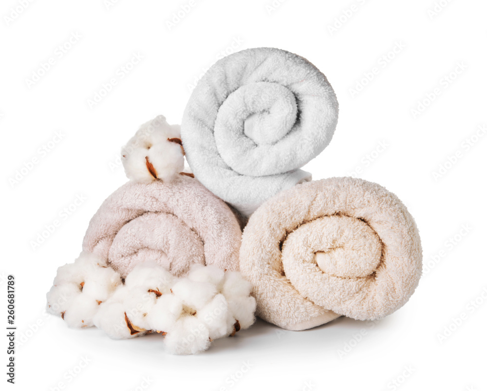 Cotton flowers with soft towels on white background