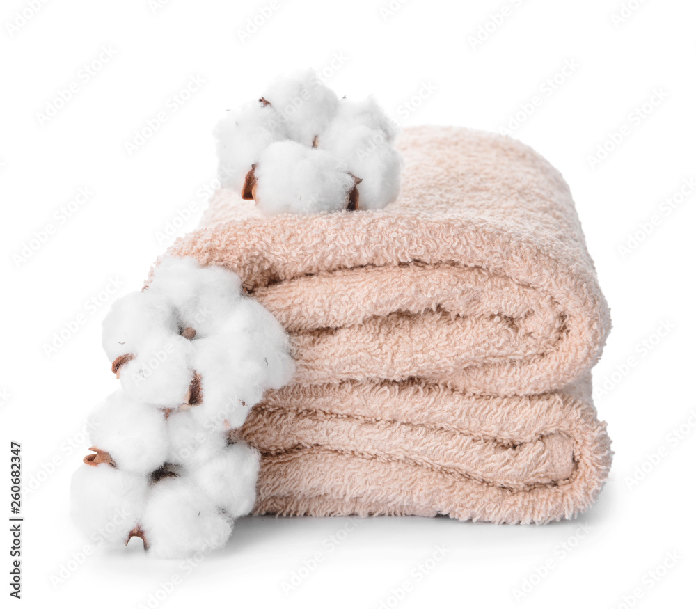 Cotton flowers with soft towels on white background