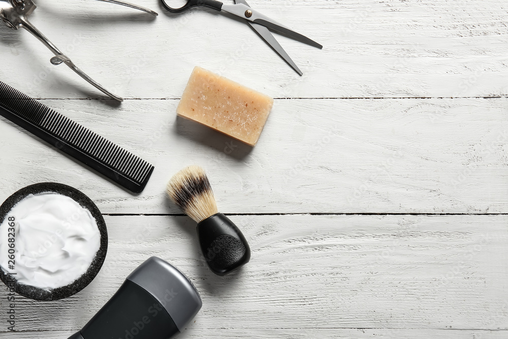 Set of male shaving accessories on white wooden background