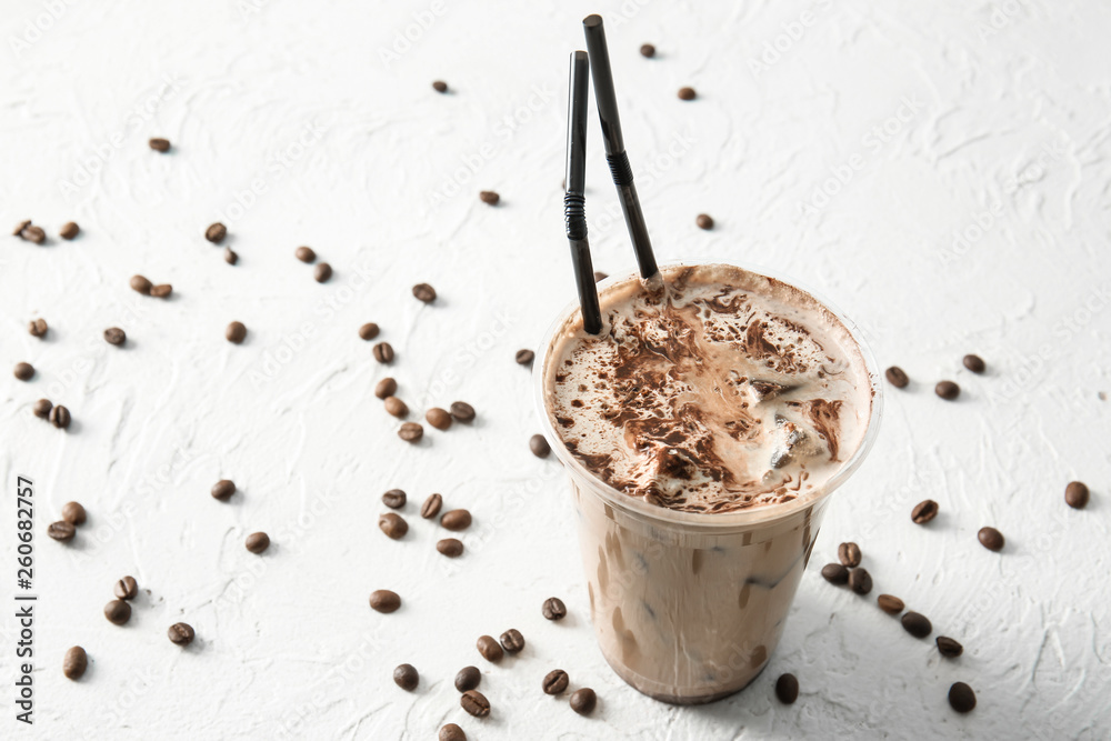 Cup of tasty frappe coffee on white background