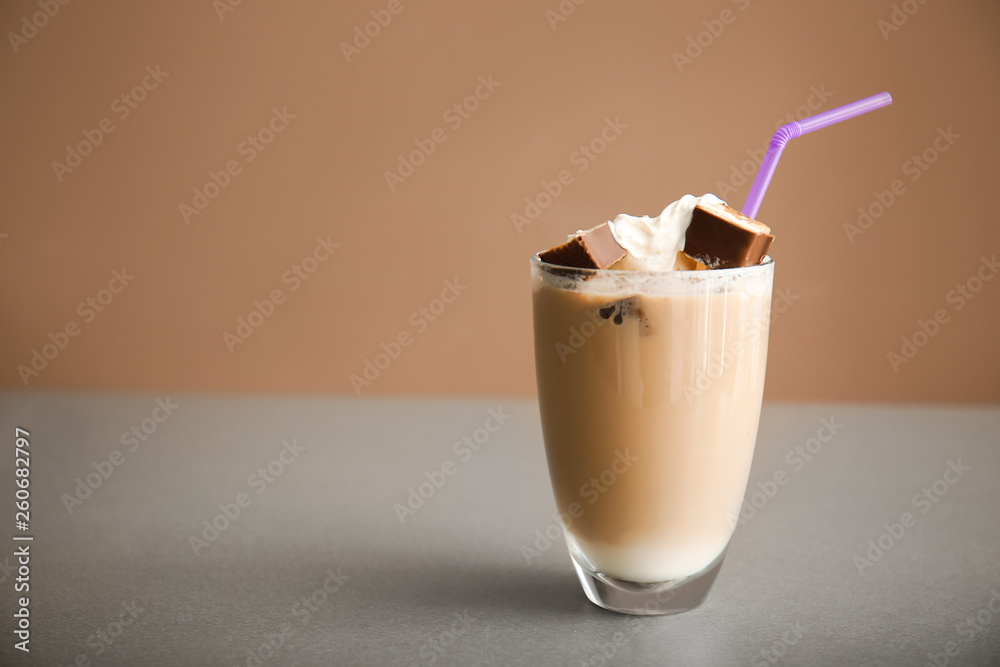 Glass of tasty frappe coffee on grey table