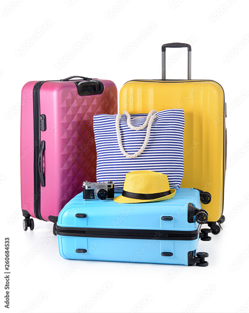 Suitcases, beach bag and photo camera on white background. Travel concept