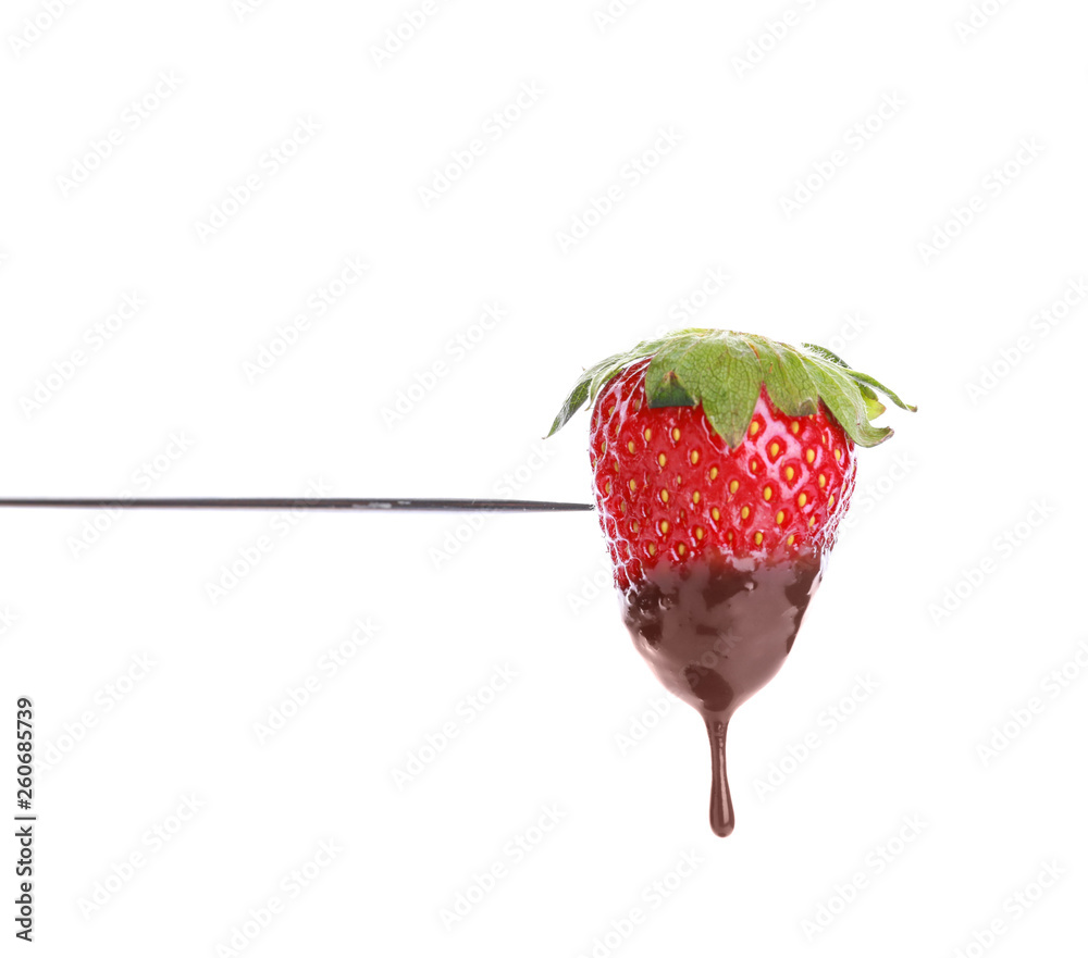 Fondue stick with chocolate covered strawberry on white background