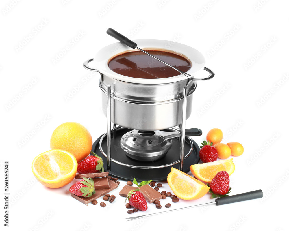 Fondue pot with melted chocolate and fruits on white background