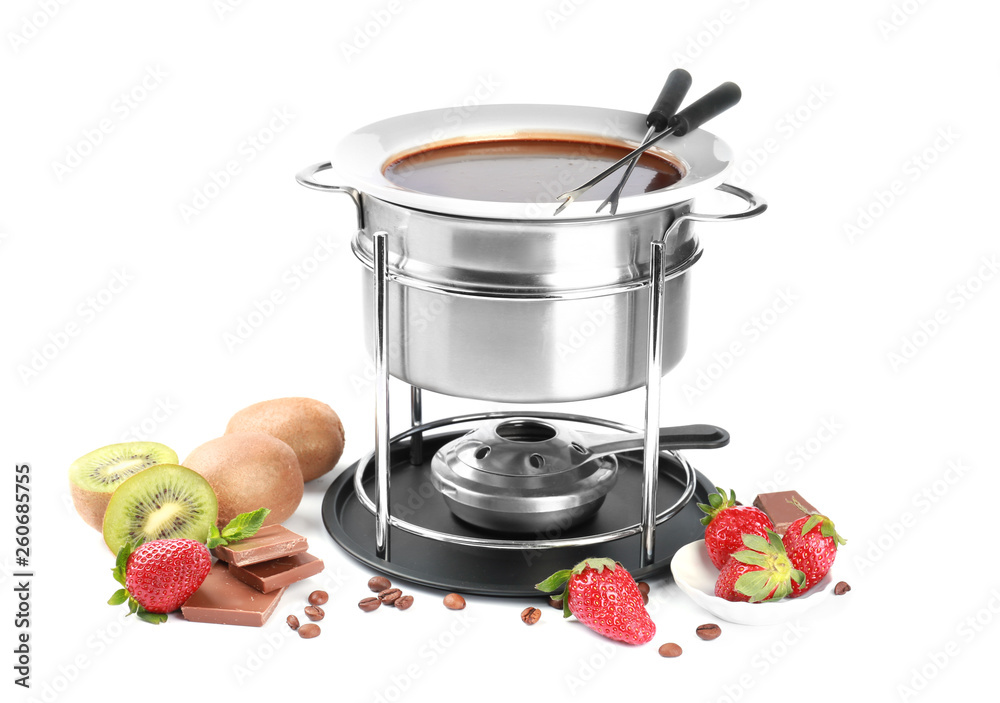 Fondue pot with melted chocolate and fruits on white background