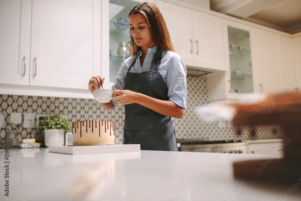 Woman preparing chocolate cake at home