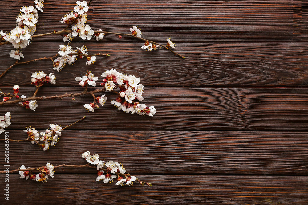 Beautiful blossoming branches on wooden background