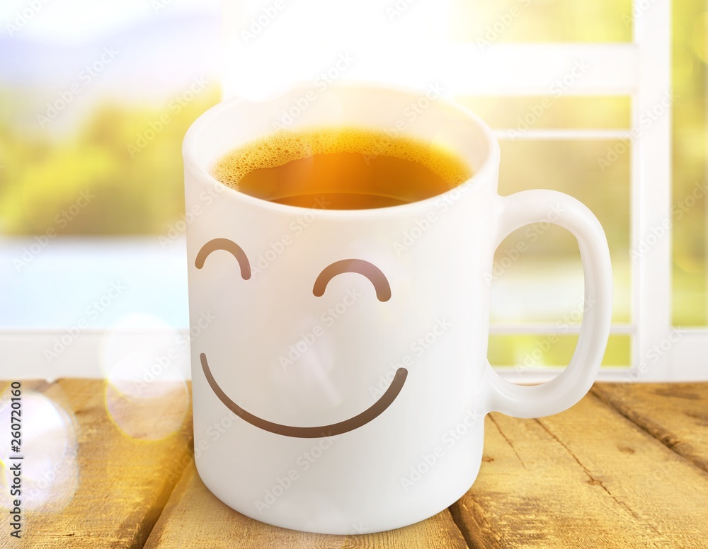 Black coffee in white cup with smiley on it on wooden  background