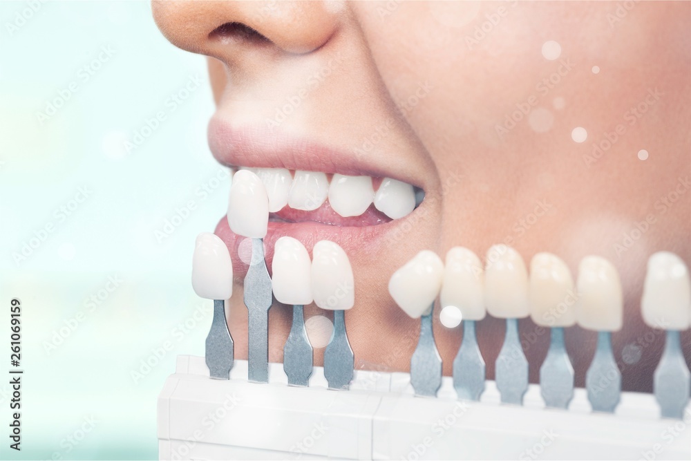 Close up portrait of Young woman Checking and selecting the color of the teeth.