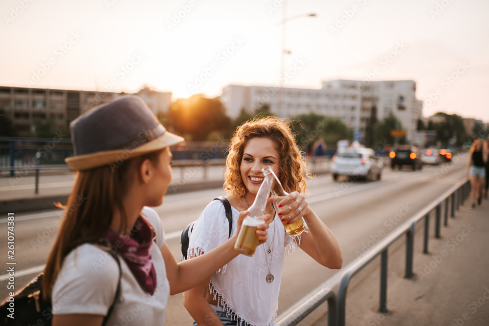 Celebrating the good times. Two young woman toasting on the city street.