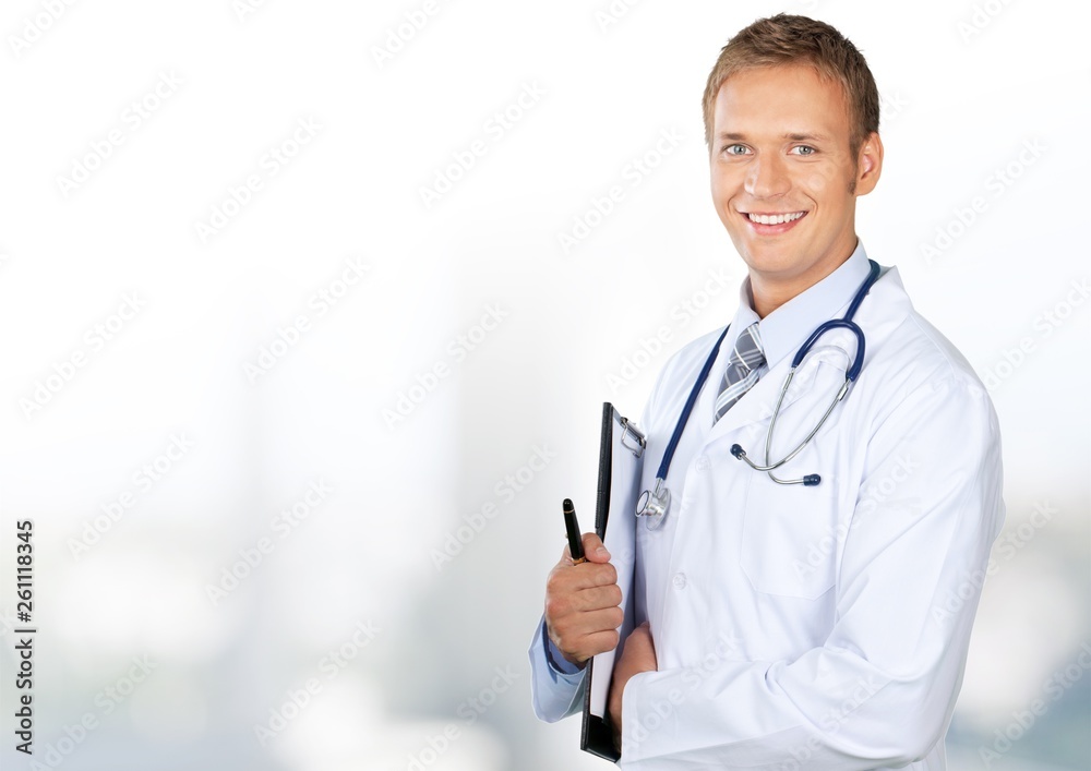 Young doctor portrait at blurred hospital background, bokeh