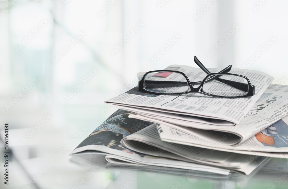 Pile of newspapers on white background