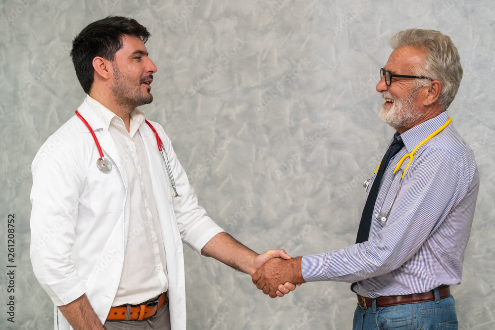 Doctor in hospital handshake with another doctor. Healthcare people teamwork and medical staff servi