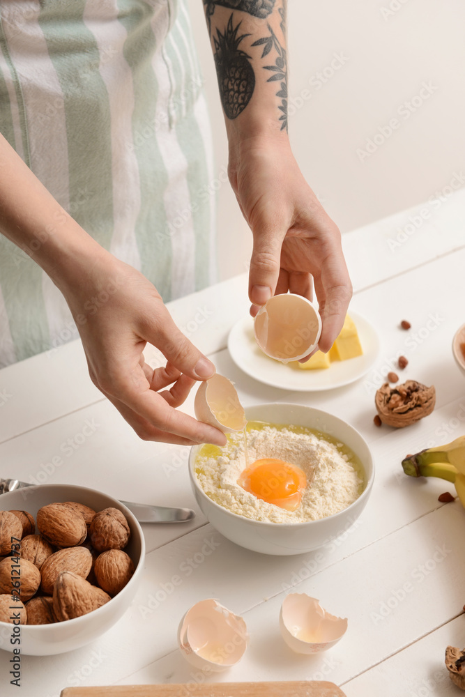 Woman preparing tasty banana bread at table