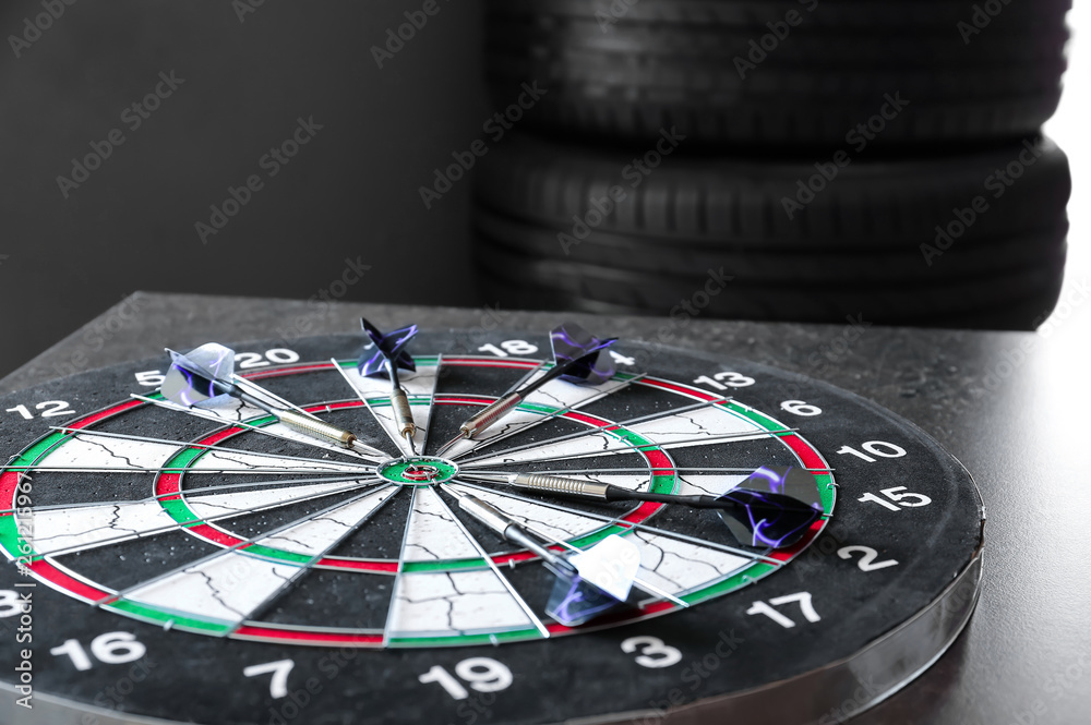 Dartboard with darts on table