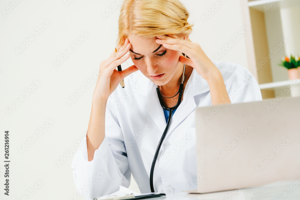 Serious doctor working in hospital office. Medical and healthcare concept.