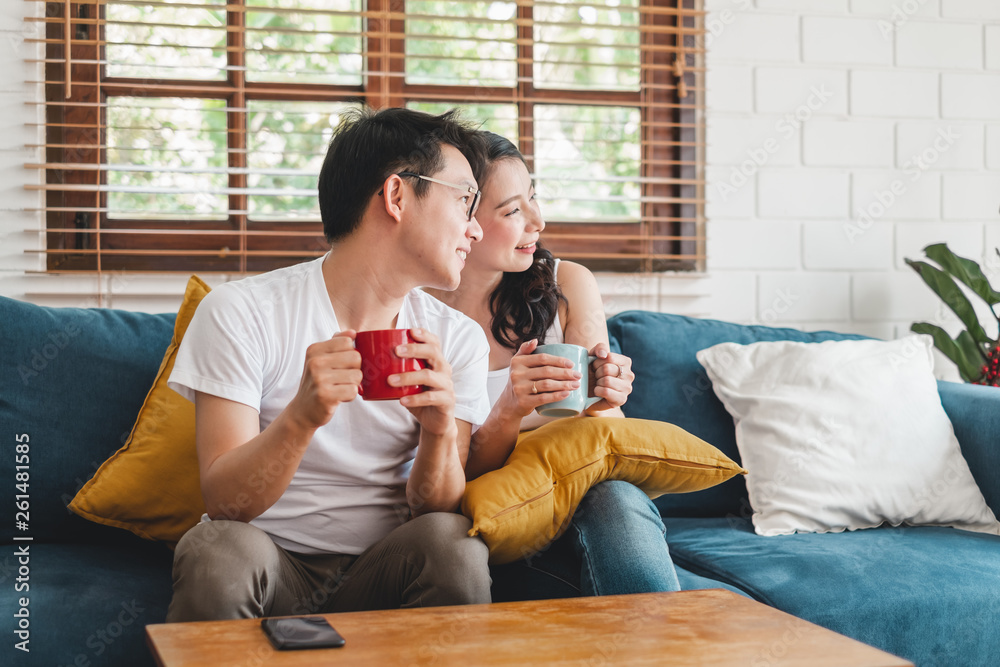 Asian couple drinking coffee at home, relaxing and home living lifestyle concept