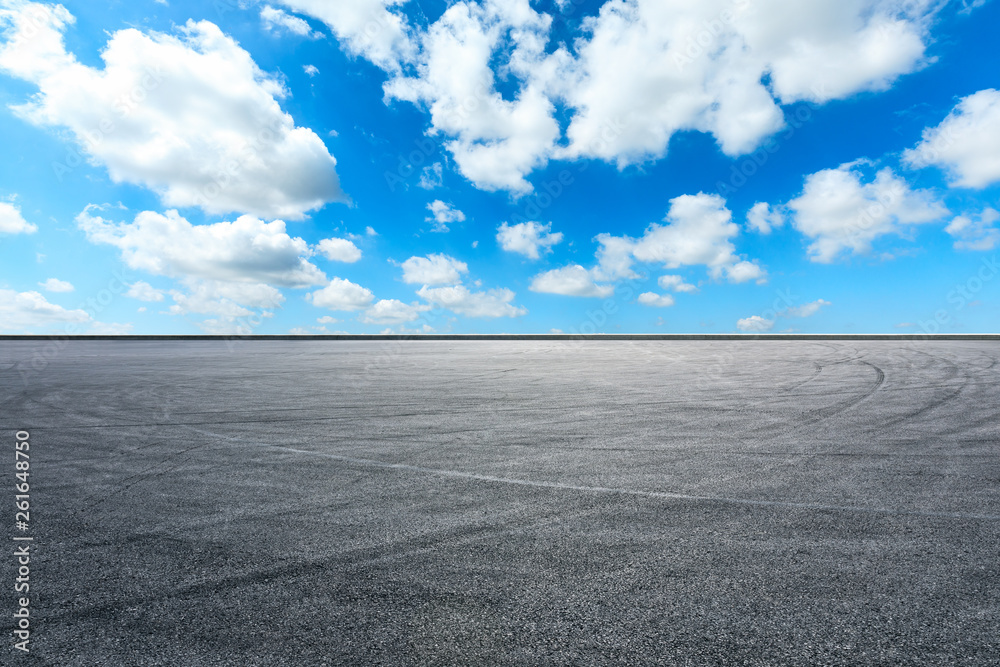 Empty asphalt race track ground and beautiful sky clouds