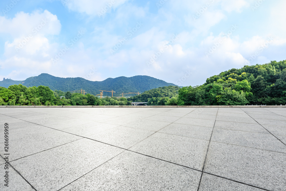 Empty square floor and green mountain with sky landscape