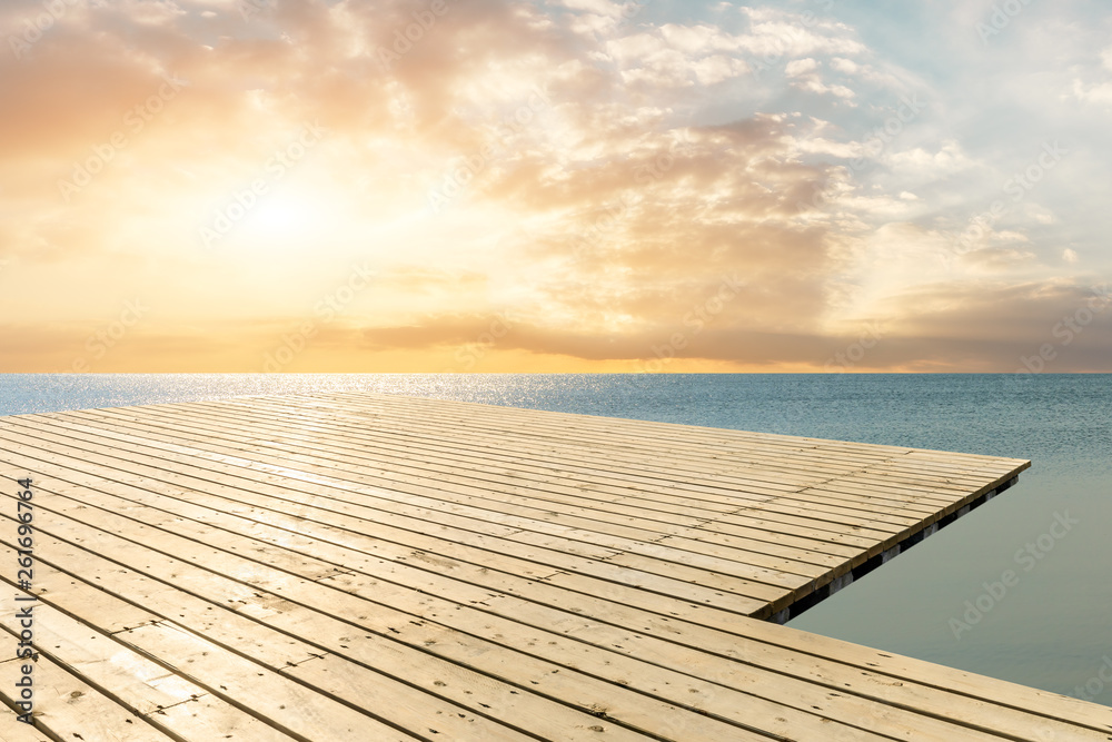 Wooden floor platform and blue sea with sky background