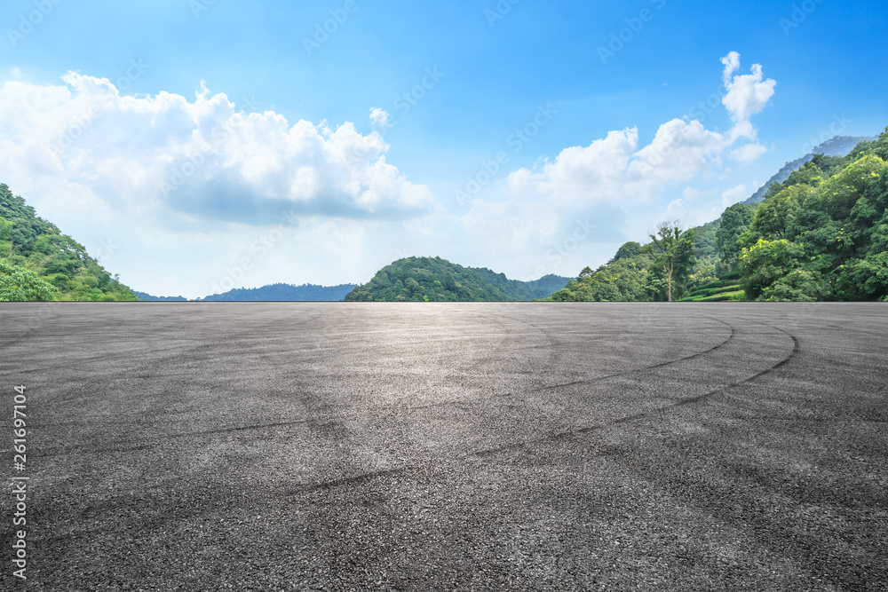 Asphalt race track ground and mountains with blue sky landscape