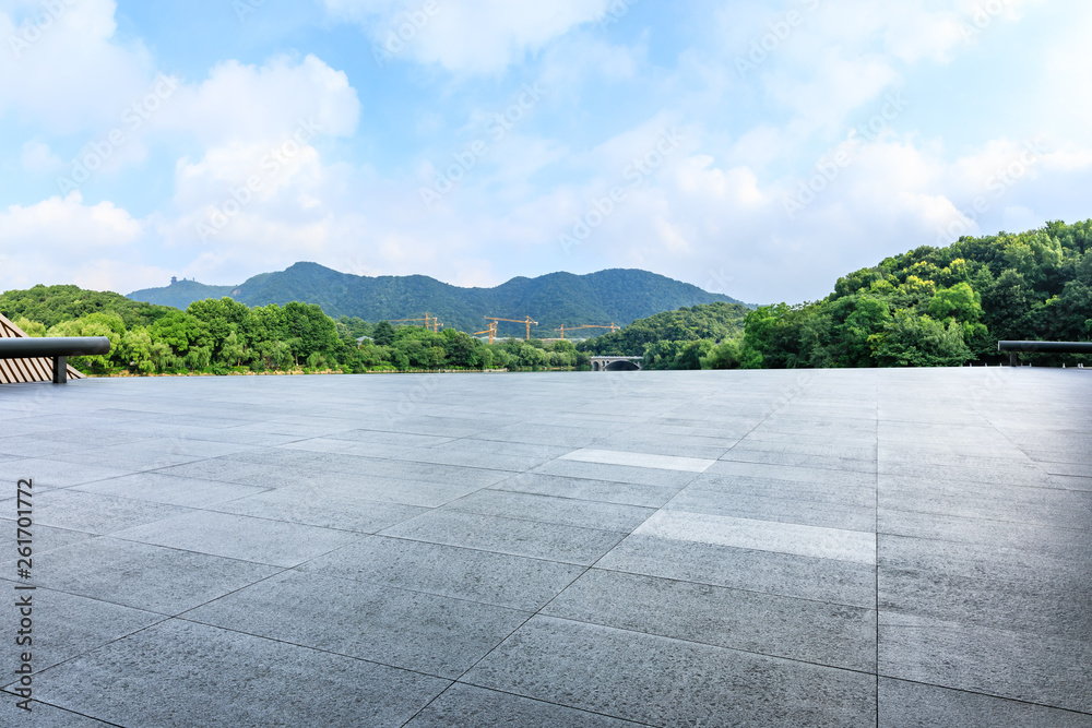 Empty square floor and green mountain with sky landscape