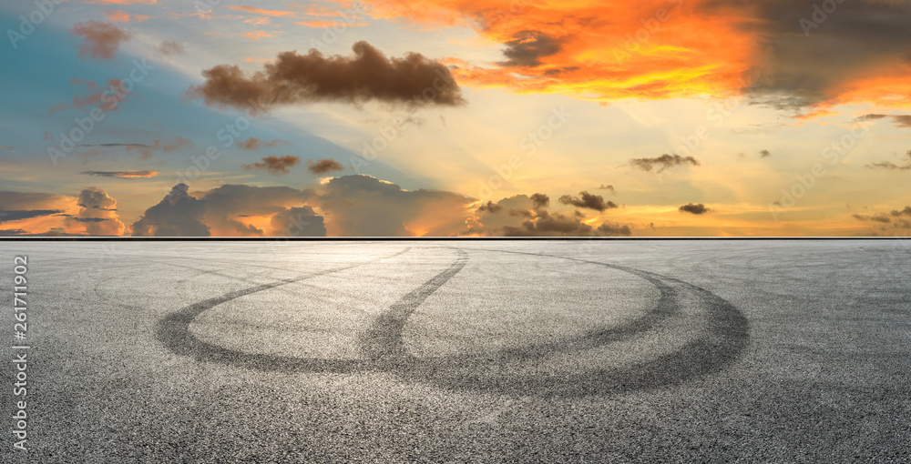 Asphalt race track ground and beautiful clouds at sunset