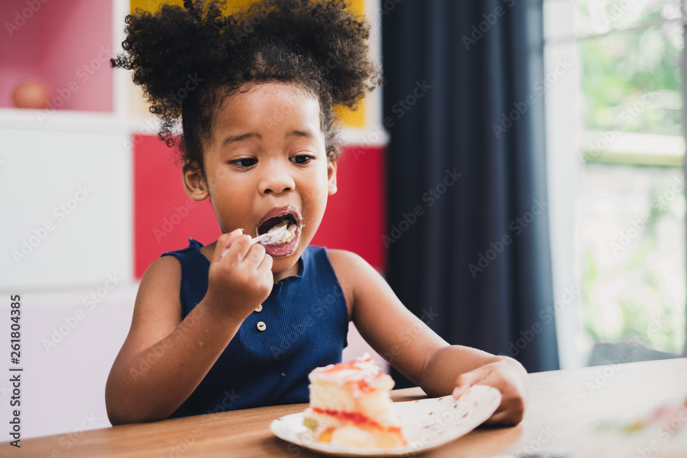 african girl kid eating sweet cake