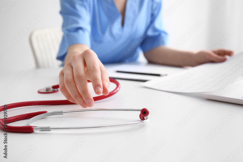 Doctor with stethoscope on table, closeup