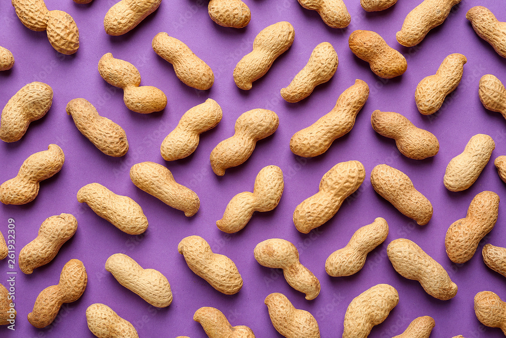 Tasty peanuts on color background