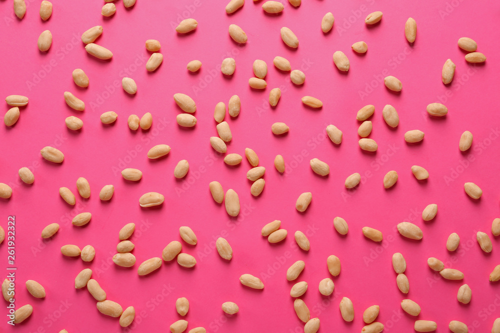 Tasty peanuts on color background