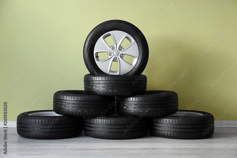 Car tires near color wall