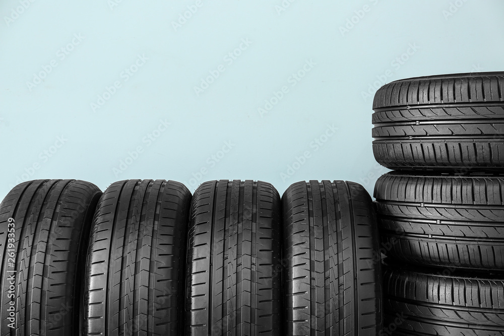 Car tires on color background