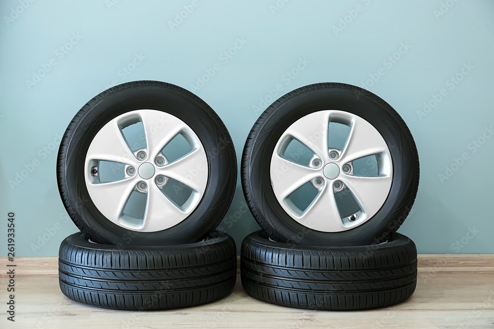 Car tires near color wall