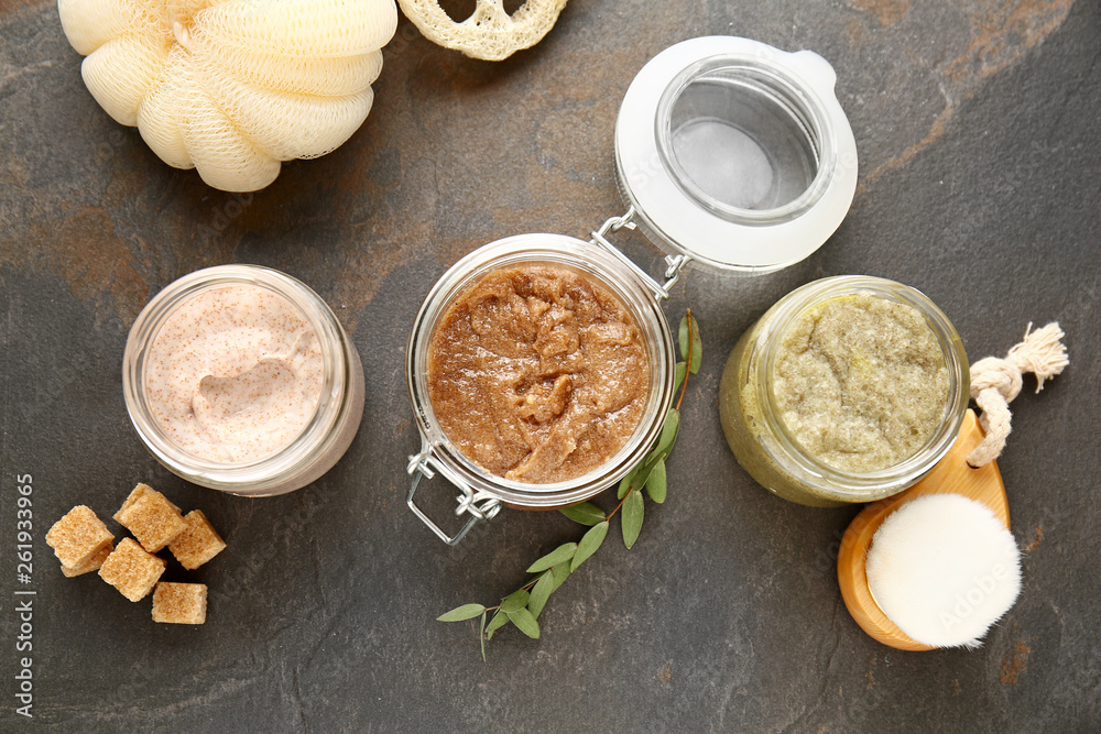 Assortment of sugar scrubs on dark table