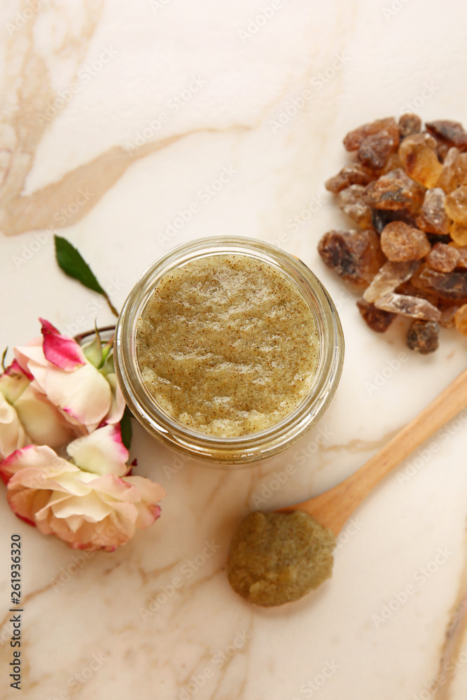 Jar with sugar scrub on light table