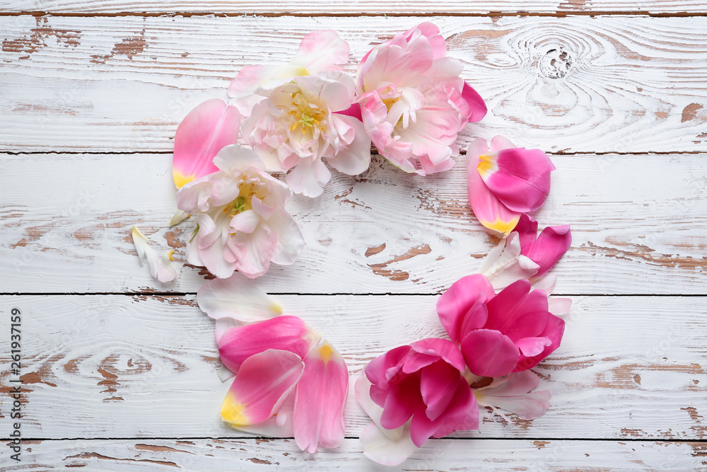 Beautiful tulip flowers on white wooden background