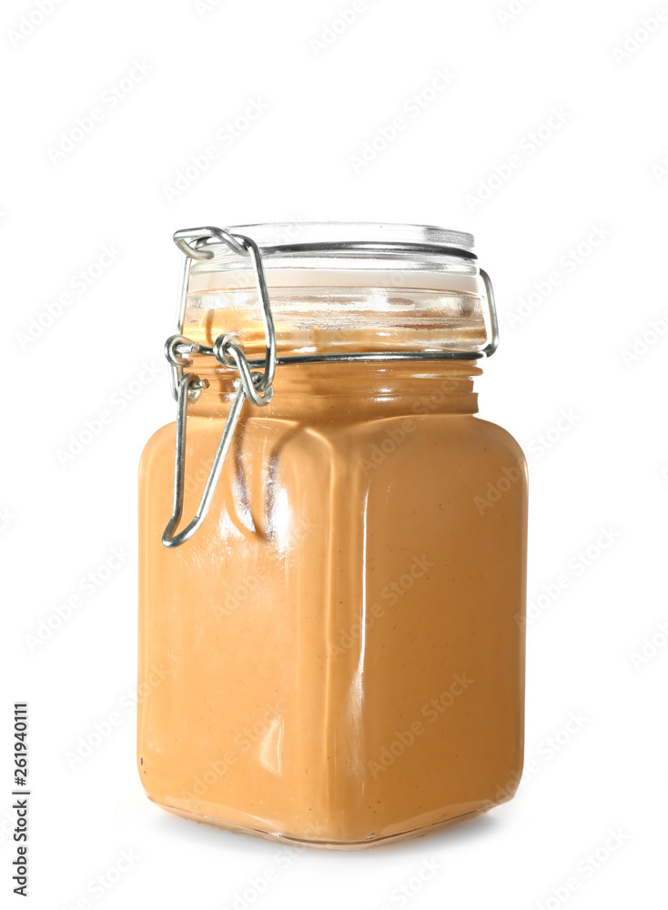 Jar with peanut butter on white background