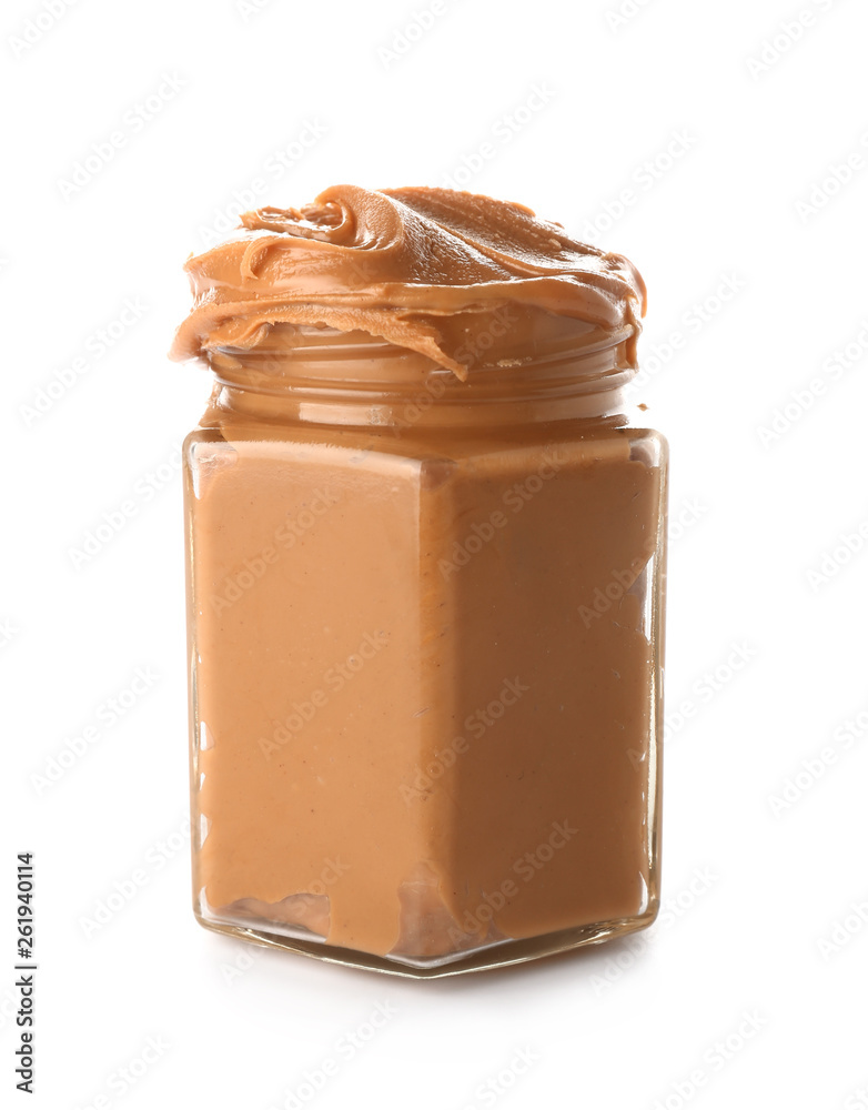 Jar with peanut butter on white background