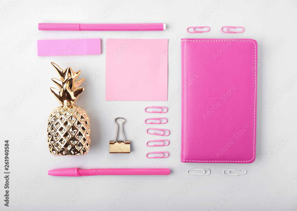 Composition with golden pineapple and stationery on white background