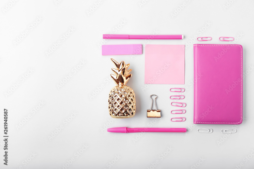 Composition with golden pineapple and stationery on white background