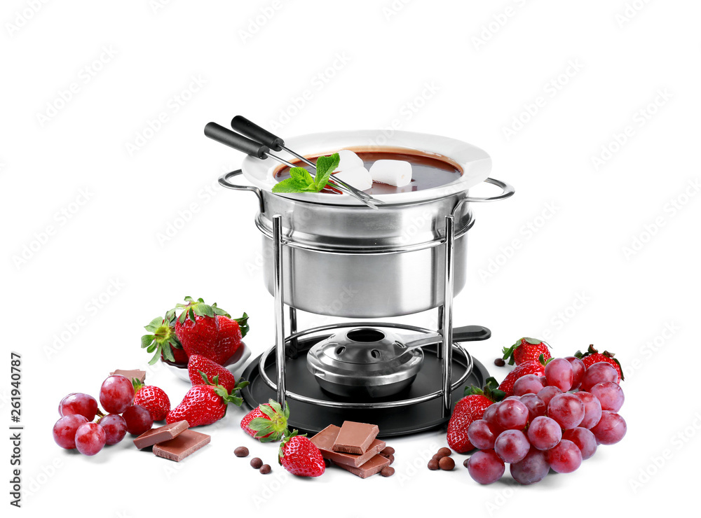 Fondue pot with melted chocolate, fruits and marshmallows on white background