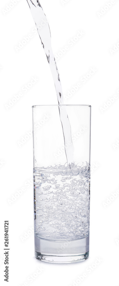 Pouring of water into glass on white background