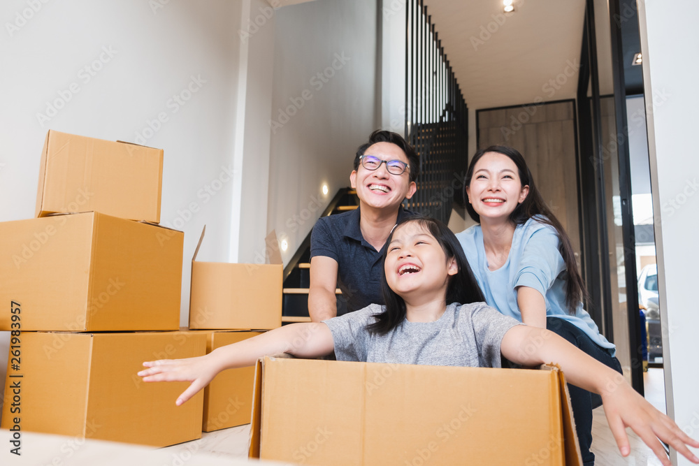 Asian family moving to new home / apartment with many packing boxes