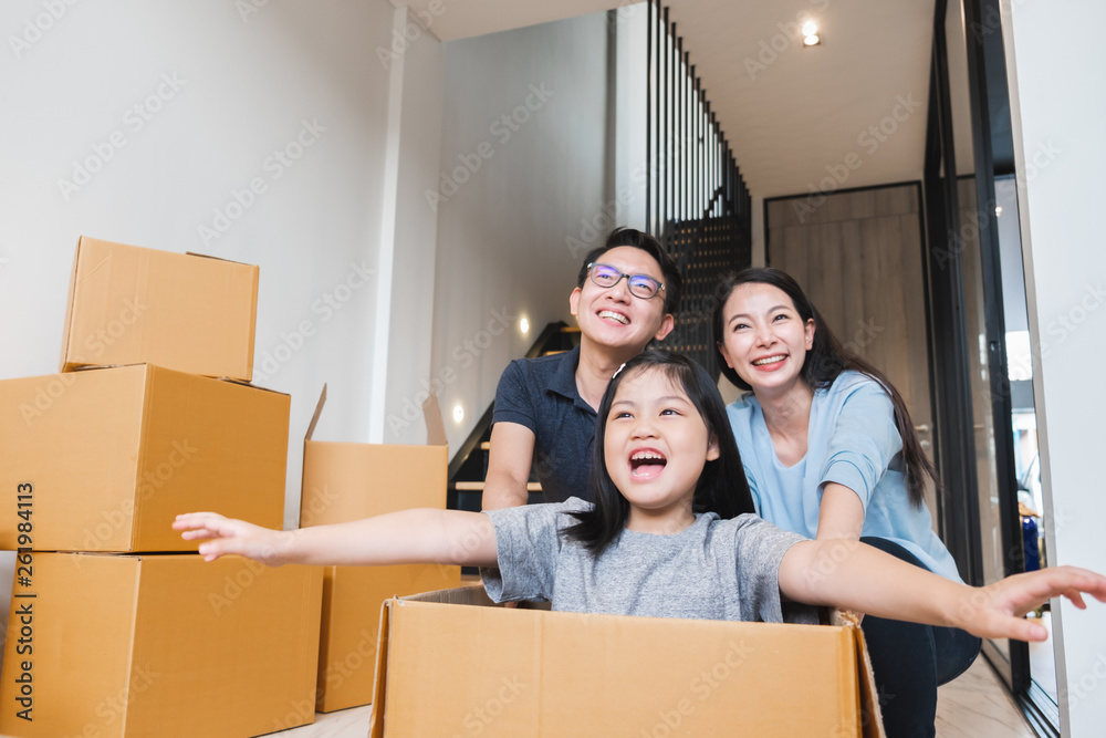 Asian family moving to new home / apartment with many packing boxes