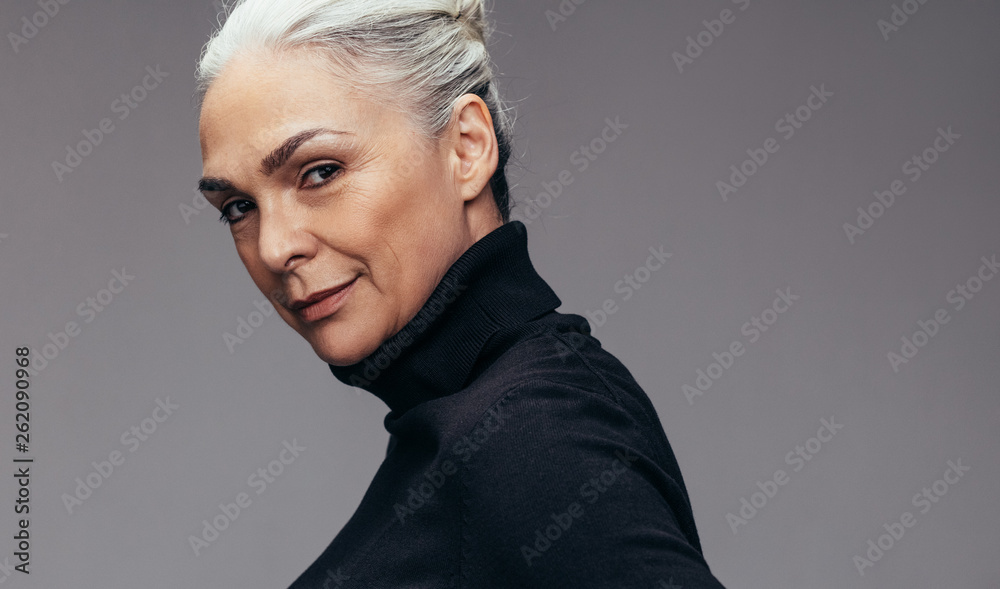 Beautiful mature woman in staring at camera