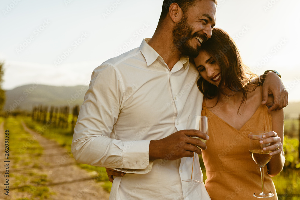 Romantic couple walking in a vineyard