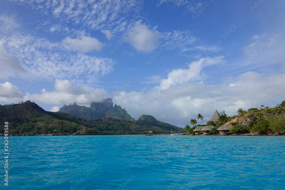 AERIAL: Flying over the tranquil ocean and towards the luxury oceanfront villas.