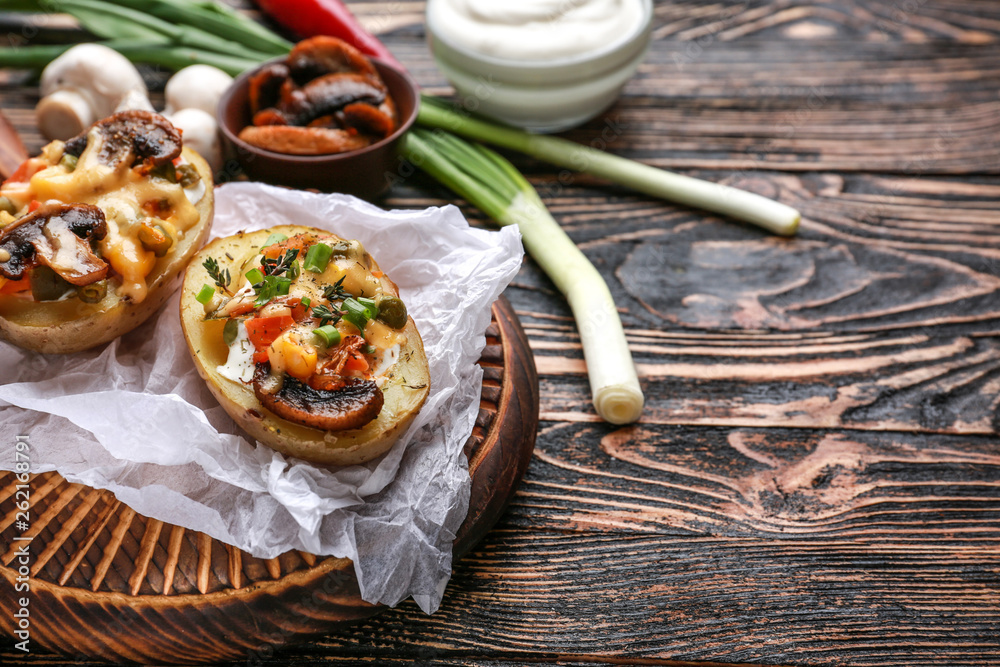 Tasty baked potato on wooden table