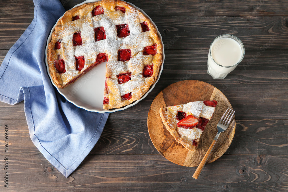 Tasty strawberry pie on wooden table